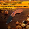 Halloween Taschenmesser Sonderedition mit orangefarbenem Kürbis-Griff und schwarzer Klinge auf Holztisch