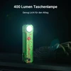 Grüne EDC Taschenlampe mit 400 Lumen und rotem Blutspritzer-Muster leuchtet im Dunkeln