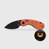 Halloween-Taschenmesser mit orangefarbenem Griff, schwarzer Klinge und im Dunkeln leuchtendem Kürbisgesicht