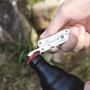 NexTool Mini Multitool öffnet eine Flasche im Freien