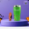 Olight orangefarbenes AION Taschenmesser und grüner Thermobecher auf Podest für Halloween-Deko im Freien